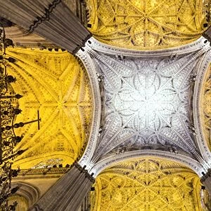 Spain, Andalusia, Seville. Ornate ceiling inside the Cathedral of Saint Mary of the See