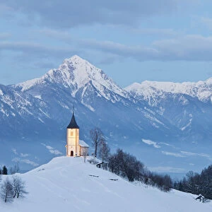 St. Primoz Church in winter, with Kamnik-Savinja Alps in background, Jamnik, Gorenjska
