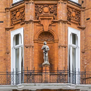 Statue on a brick terraced house, Kensington, London, England, UK