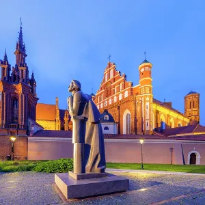 A Statue of the Polish Poet Adam Mickiewicz in front of St. Anne's Church and the Church of St. Francis and St. Bernard at Dusk, Vilnius, Lithuania A Statue of the Polish Poet Adam Mickiewicz in front of St. Anne's Church and the Church of St. Francis and St. Bernard at Dusk, Vilnius, Lithuania