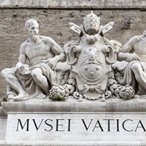 Statues of Michelangelo and Raphael at the main doorway of the Vatican Museums, Rome
