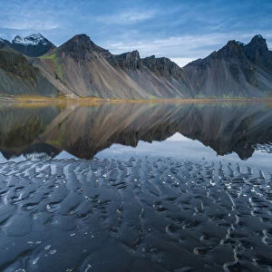 Stokksnes, Iceland. Vestrahorn mountain mirrors in the waters of the Stokksnes bay