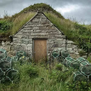 Stone fisherman's hut and lobster pots in the village of Keiss, Caithness, Scotland. Autumn (September) 2022