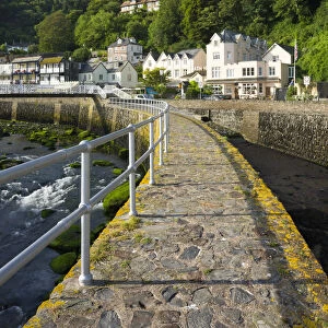 Stone harbour wall and village of Lynmouth on a summer morning, Exmoor National Park