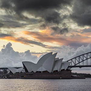 Storm clouds over Sydney Opera House and Sydney Harbour Bridge at sunset, Sydney