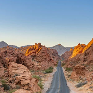 Straight road between red rocks at sunrise, Valley of Fire State Park, Nevada