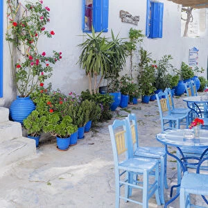 Streetside cafe tables and chairs, Amorgos, Cyclades Islands, Greece, Europe