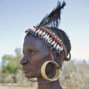 A striking old Pokot woman wearing the traditional beaded ornaments of her tribe which denote her married status. The Pokot are pastoralists speaking a Southern