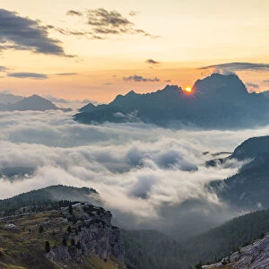 The sun rises in Cortina d Ampezzo hidden by the morning fog, Belluno district
