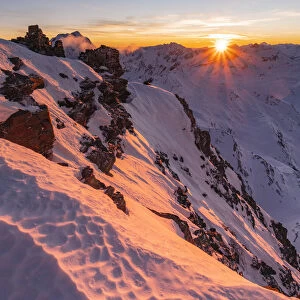 Last sunlight from Vallombrina mountain in the Stelvio National Park during a winter