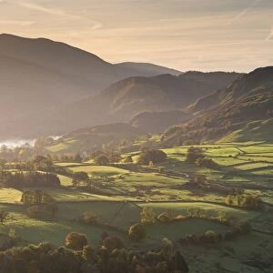 Sunlit rolling countryside near Keswick, Lake District National Park, Cumbria, England