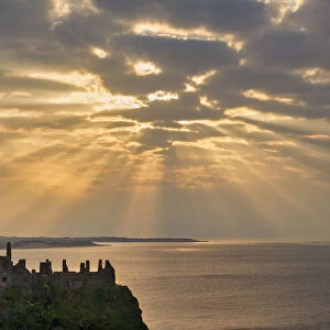 Sunrays over Dunluce Castle at Sunset, County Antrim, Northern Ireland