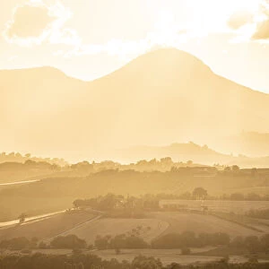 Sunset backlight over hills in Marche region, Central Italy