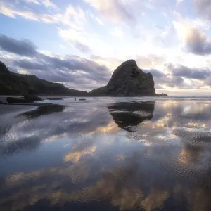 Sunset reflections at Piha Beach, Auckland, New Zealand