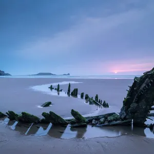 Sunset over the shipwreck of the Helvatia on Rhossili Bay, Gower, South Wales, UK. Spring (March) 2022 Sunset over the shipwreck of the Helvatia on Rhossili Bay, Gower, South Wales, UK. Spring (March) 2022