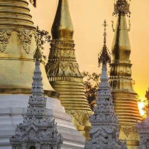 Sunset behind temples of Shwedagon Pagoda, Yangon, Myanmar