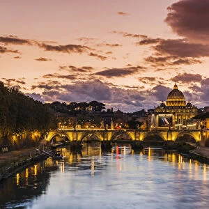 Sunset view of Tiber river with St. Peters Basilica in the background, Rome