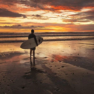 Surfer at Playa Santa Teresa at sunset, Peninsula de Nicoya, Guanacaste, Costa Rica
