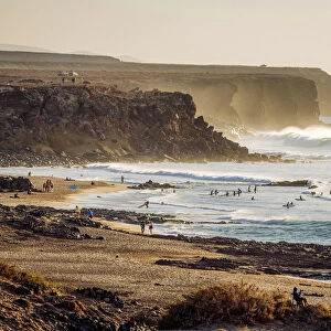 Surfers in El Cotillo coastline, Fuerteventura, Canary Islands. Spain