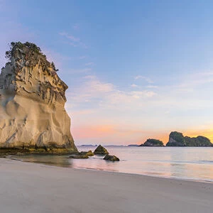 Te Hoho rock at Cathedral Cove at sunrise, with Poikeke and Motueka islands in the