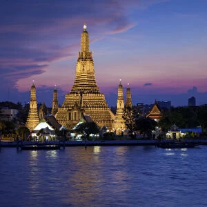Thailand, Bangkok, Wat Arun, Temple Of The Dawn & Chao Phraya River illuminated at sunset