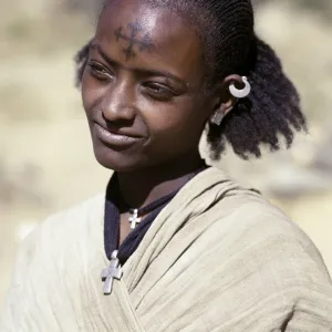 A Tigray woman has a cross of the Ethiopian Orthodox