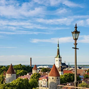 Toompea Hill Lookout Point, view over the Old Town towards St Olafs Church at sunset, Tallinn, Estonia