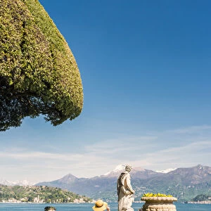 Tourist admiring Villa del Balbianello gardens on Punta di Lavedo, Lenno, Como province