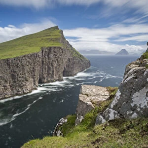 Towering sea cliffs on the island of Vagar in the Faroe Islands, Denmark. Summer