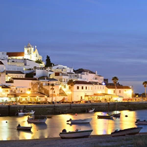 The traditional fishing village of Ferragudo at dusk, bordering the Arade river. Algarve