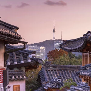 Traditional houses in Bukchon Hanok village and Namsan Seoul Tower at dusk, Seoul
