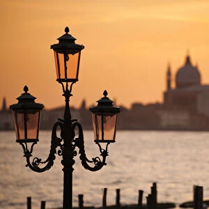 Traditional lamps and The Chiesa del Santissimo Redentore at sunset, Venice, Veneto