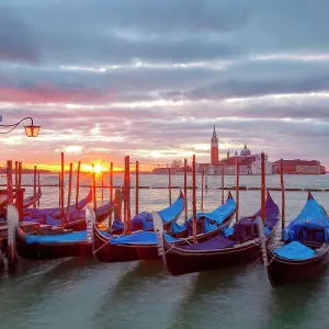 Some traditional venetian gondolas moored at Riva degli Schiavoni at dawn with St. george Island on the backgrund, Venice, Veneto, Italy Some traditional venetian gondolas moored at Riva degli Schiavoni at dawn with St. george Island on the backgrund, Venice, Veneto, Italy