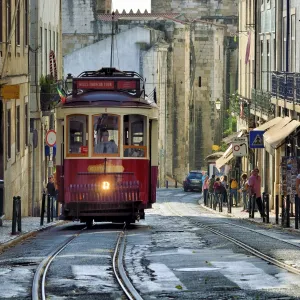 A tramway in Alfama district with the Motherchurch (Se Catedral) in the background