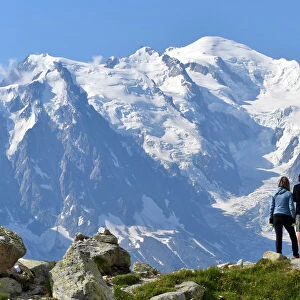 Trekkers with Mont Blanc massif on background, Close to Lac Blanc, Chamonix, France