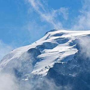 Trekkig at Stelvio pass, silhouette of an hiker facing the Ortles. Valtellina valley