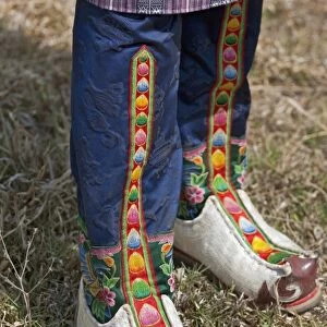 Tsholham - traditional knee-length boots that are worn by Bhutanese men during important ceremonial occasions. They are commonly hand-stitched from cow or sheep hide and decorated with brocade