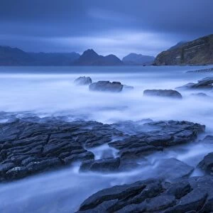 Twilight on the rocky coast of Elgol, looking across to the Cuillin mountains, Isle of Skye