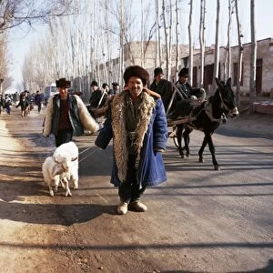 Uighur man with sheep on the road to Kashgar market