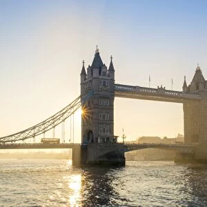 United Kingdom, England, London. Early morning sun rising behind Tower Bridge over