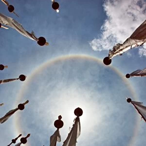 A very unusual full circle rainbow phenomenon surrounded by lungdhar Buddhist prayer flags