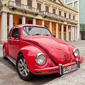 Uruguay, Montevideo, Red Volkswagen Beetle parked in front of the Estevez Palace
