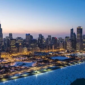 USA, Illinois, Chicago. Aerial dusk view of the city and Millennium Park in winter