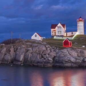 USA, Maine, York Beach, Nubble Light Lighthouse with Christmas decorations, dusk