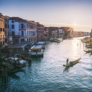 Venice, Veneto, Italy. Gondola in Grand Canal at sunset from Rialto bridge