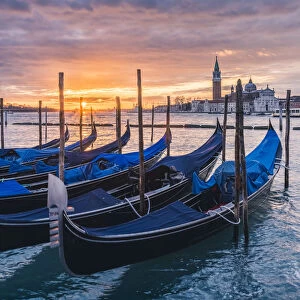 Venice, Veneto, Italy. Gondolas moored on Riva degli Schiavoni at sunrise