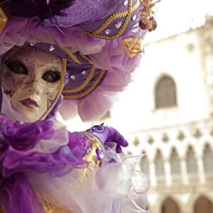 Venice, Veneto, Italy; A masked character in front of the Palazzo dei Dogi during Carnival