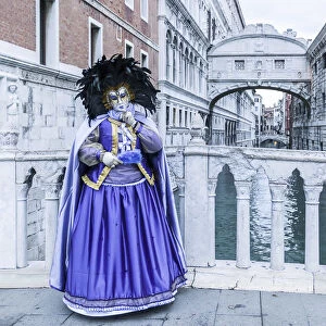 Venice, Veneto, Italy. Traditional costume for the historical Carnival and Bridge