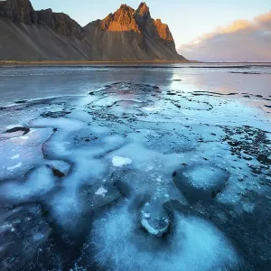 Vestrahorn and frozen black sand at sunset, Stokksnes peninsula, Hofn, Austurland, Iceland Vestrahorn and frozen black sand at sunset, Stokksnes peninsula, Hofn, Austurland, Iceland