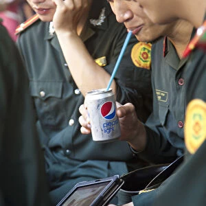 Vietnamese Soldiers enjoying modern Western products, Hanoi, Vietnam